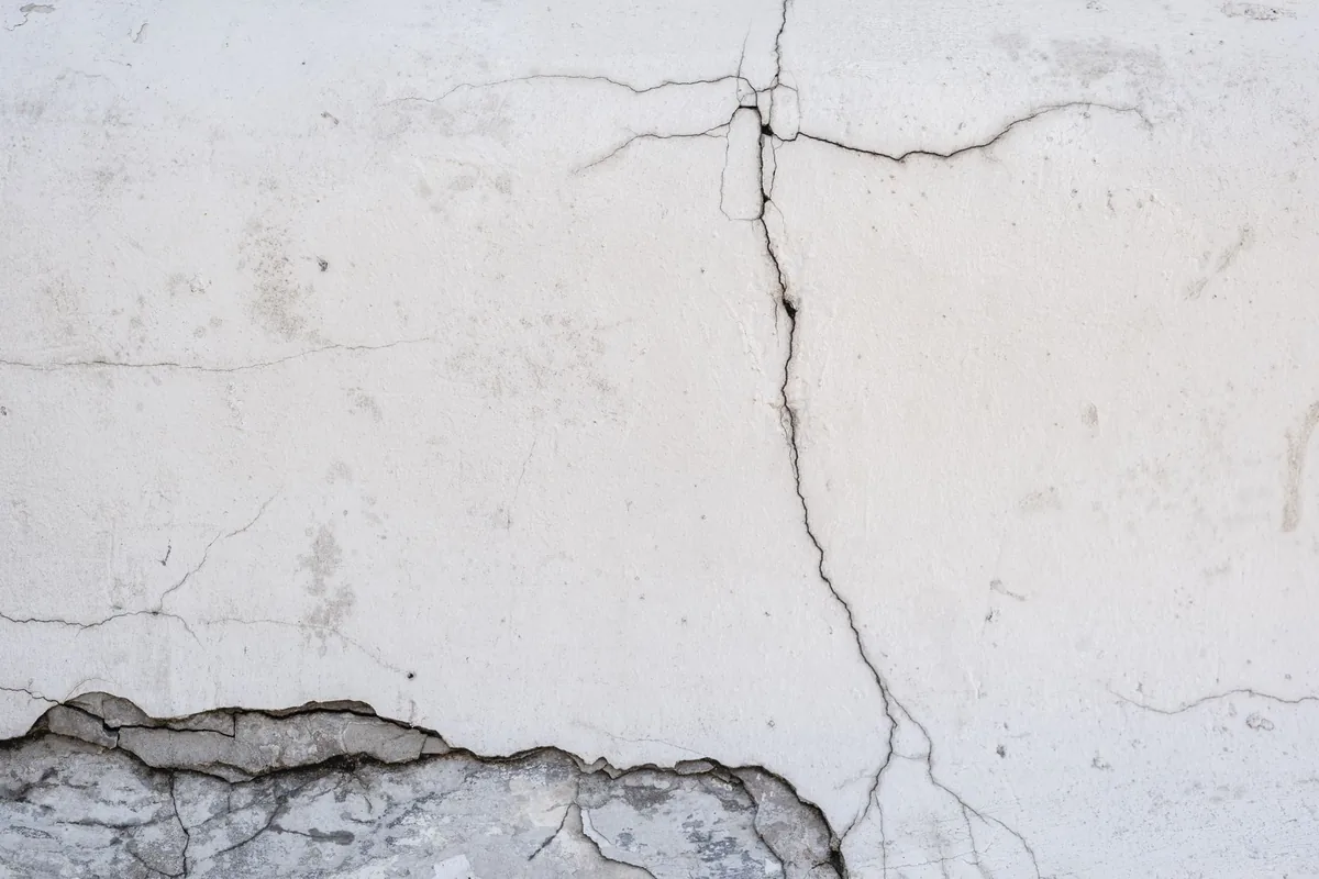 A crack running down a white plastered wall