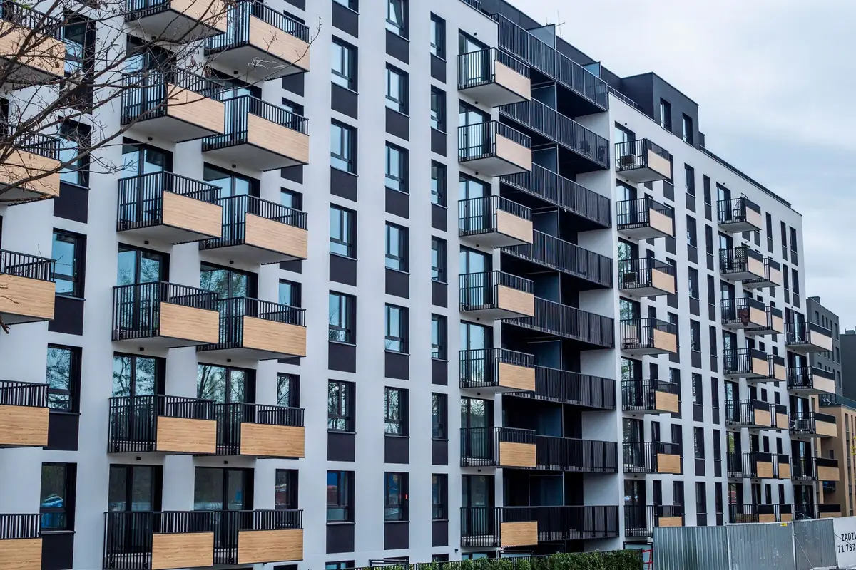 A newly finished apartment building with rows of balconies