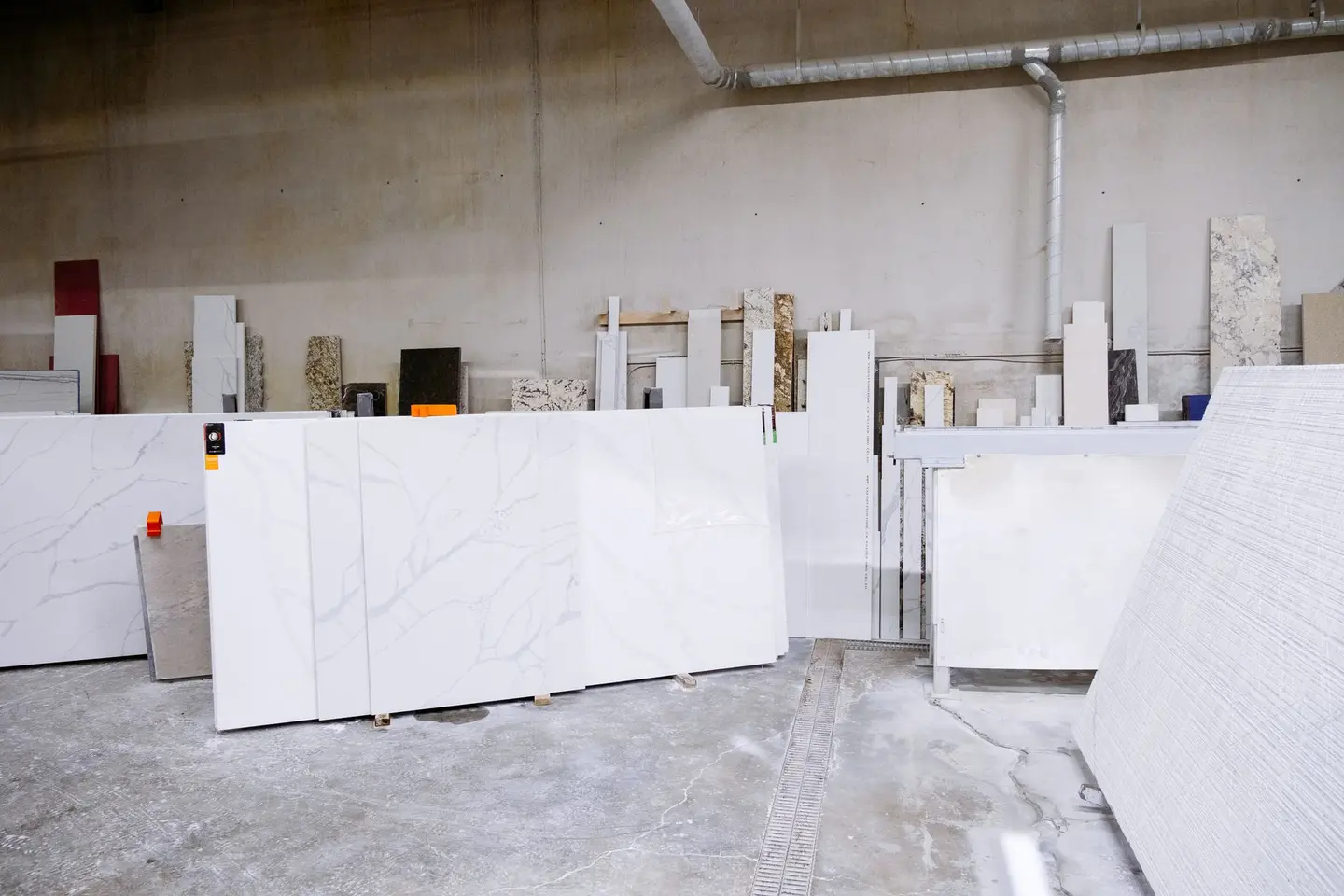 Large stone slabs standing upright in a warehouse