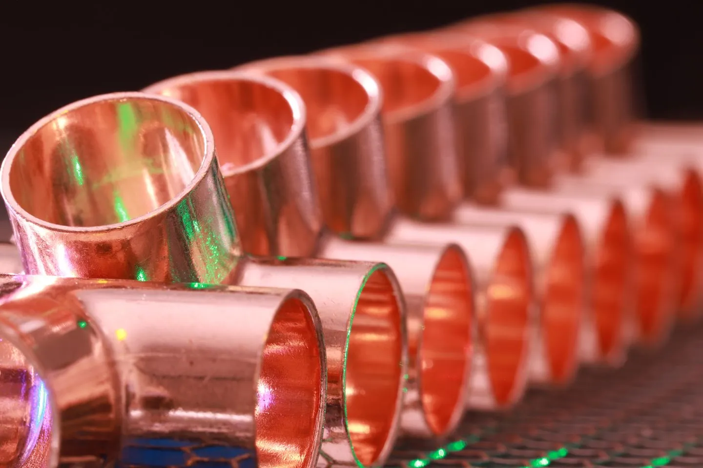 A neutral, unbranded close-up photograph of brass and copper plumbing fittings arranged in a row. No brand marks, no logos, no people.