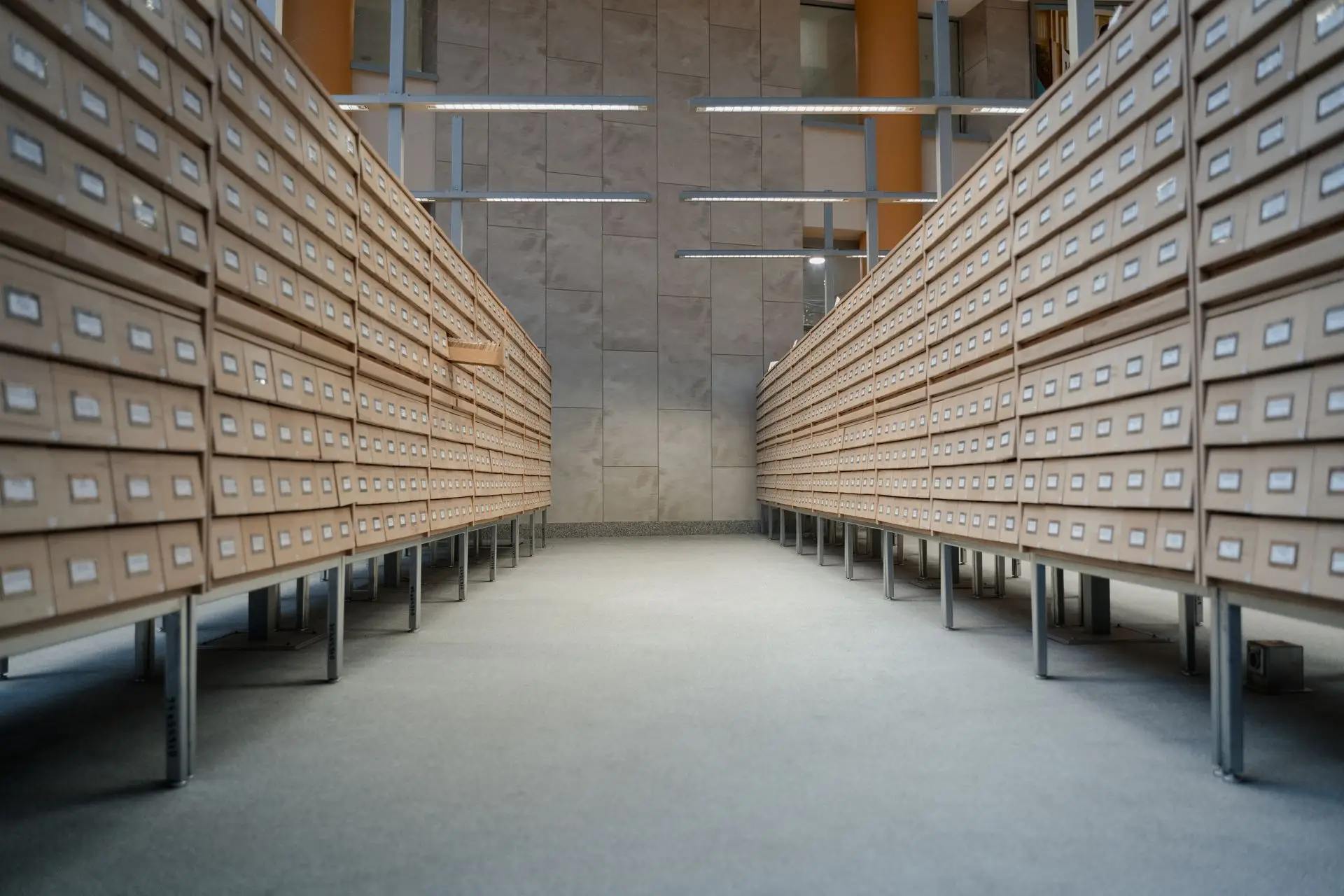 Rows of archive drawers in a records room, holding documents kept for the long term